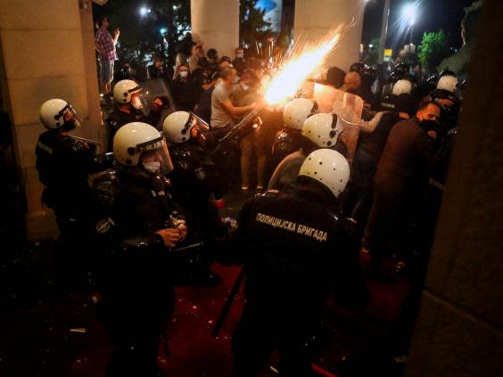 Protesters and police clash in front of the National Assembly building in Belgrade (AFP via Getty Images)