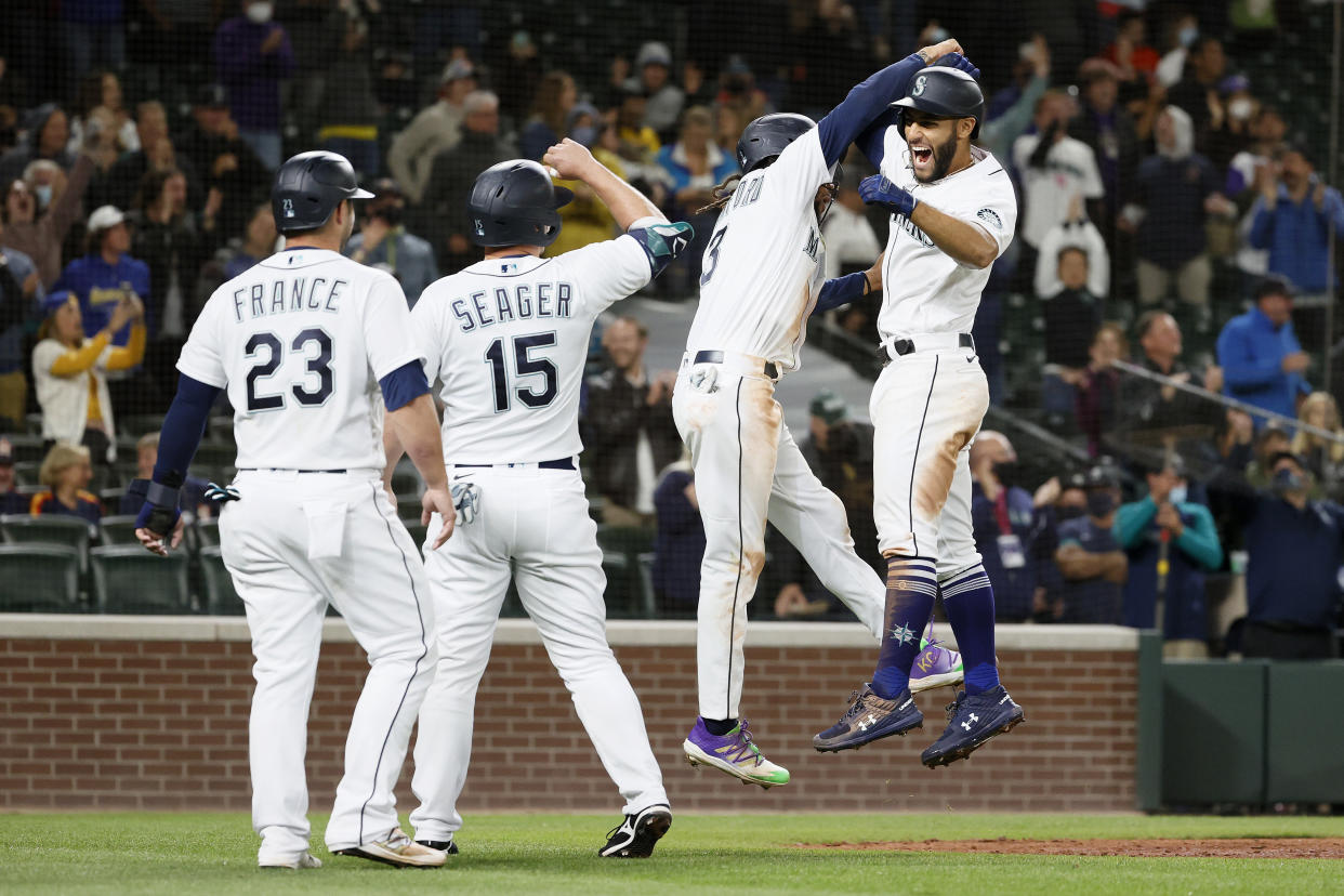 SEATTLE, WASHINGTON - AUGUST 31: Abraham Toro #13 of the Seattle Mariners reacts after his grand slam home run with Ty France #23, Kyle Seager #15 and J.P. Crawford #3 during the eighth inning against the Houston Astros at T-Mobile Park on August 31, 2021 in Seattle, Washington. (Photo by Steph Chambers/Getty Images)