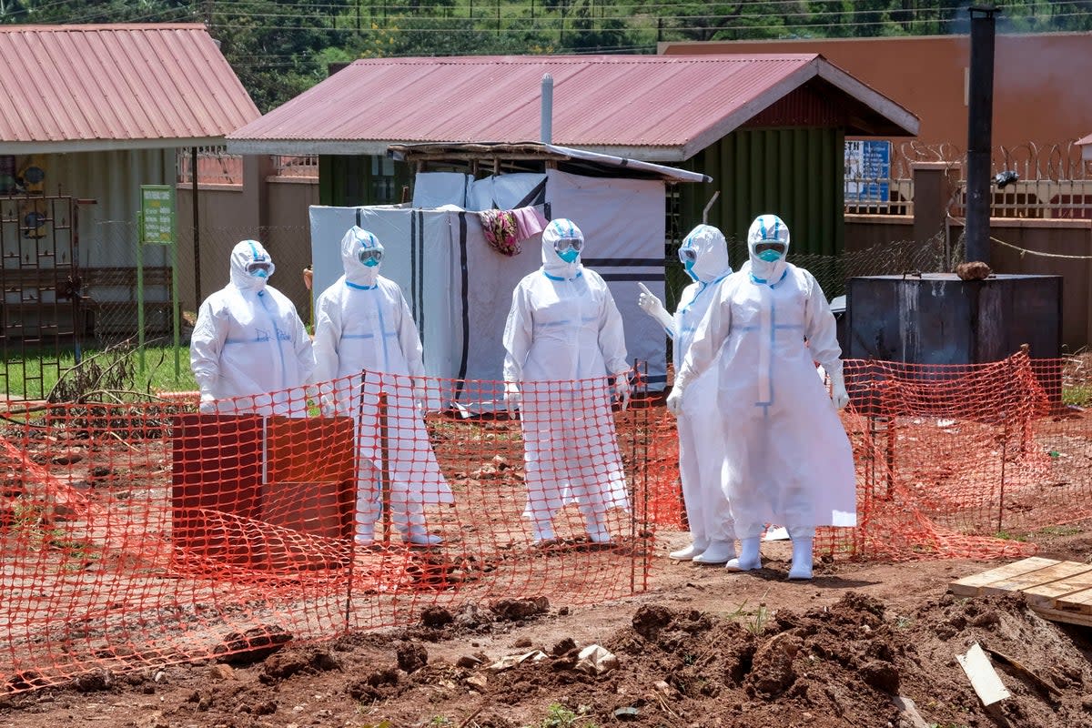 Doctors walk inside the Ebola isolation section of Mubende Regional Referral Hospital, in Mubende, Uganda, Thursday, Sept. 29, 2022. (AP)