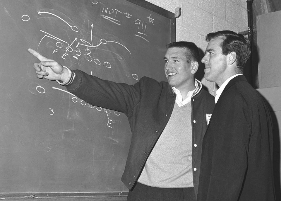 FILE - In this December 1965 file photo, Baltimore Colts quarterback John Unitas, left, and flanker back Jimmy Orr check a play diagram on the blackboard in Baltimore as the Colts prepared for an NFL football playoff game with the Green Bay Packers. Unitas was out for the season with a knee injury. Orr, a sure-handed wide receiver who played for the Pittsburgh Steelers and the Colts, died Tuesday, Oct. 27, 2020. He was 85. His death was confirmed Wednesday by Edo Smith and Sons Funeral Home in Brunswick, Ga. (AP Photo/William Smith, File)