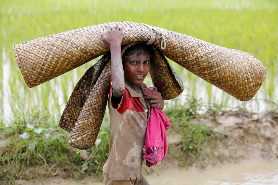 A Rohingya refugee boy walks in the water after crossing the Bangladesh-Myanmar border in Teknaf, Bangladesh, on Sept. 1, 2017.