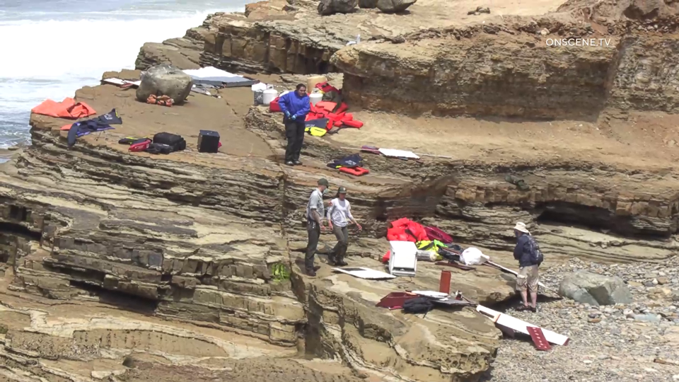 Items from a boat sit on a cliff at Cabrillo National Monument near where it capsized just off the San Diego coast on Sunday, May 2, 2021. / Credit: OnScene.TV