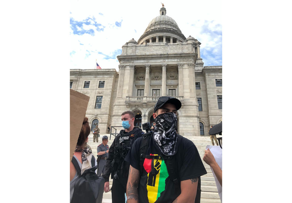 CORRECTS NAME TO TOBY ANDERSON- Toby Anderson, 30, attends a rally in Providence, Rhode Island, on Friday, June 5, 2020. Anderson, who is biracial, said he downloaded the Signal app for encrypted communications several days earlier at the request of his mom. “She’s a black woman in America,” he said, and thus was worried about his safety. (AP Photo/Matt O’Brien)