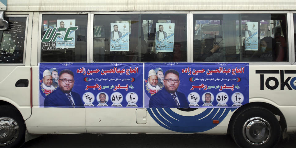 In this Tuesday Oct. 16, 2018 photo, a bus is covered with posters for candidate, Alhaj Abdul Hossain Hossainzada, ahead of parliamentary elections, in Kabul, Afghanistan. The elections are being held Saturday despite deep security concerns and ongoing fighting in as many as 20 out of the country’s 34 provinces. The vote comes amid a particularly vicious campaign by the Taliban and the Islamic State group, which have been staging near-daily attacks and there have also been concerns over the transparency of the vote. (AP Photo/Rahmat Gul)