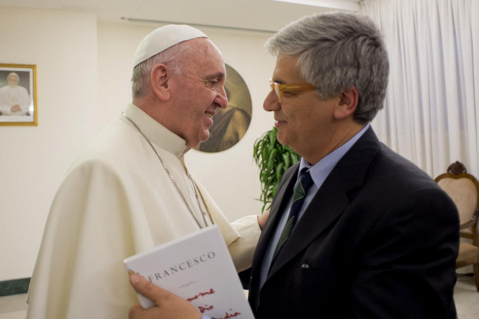 FILE - In this Monday, Jan. 11, 2016, file photo, Pope Francis greets Italian journalist Andrea Tornielli at the Vatican. Several prominent lawyers have published stinging academic critiques and legal opinions about the Vatican's recently concluded "trial of the century," where Cardinal Angelo Becciu and nine others were convicted of several financial frauds, highlighting violations of basic defense rights and rule of law norms that they warn could have consequences for the Holy See going forward. After the first verdicts were issued, the Vatican's editorial director, Andrea Tornielli, insisted that the process had been fair, that the judges had full independence, and that the trial was carried out "in full respect of the guarantees for the suspects." (L'Osservatore Romano/Pool Photo via AP)