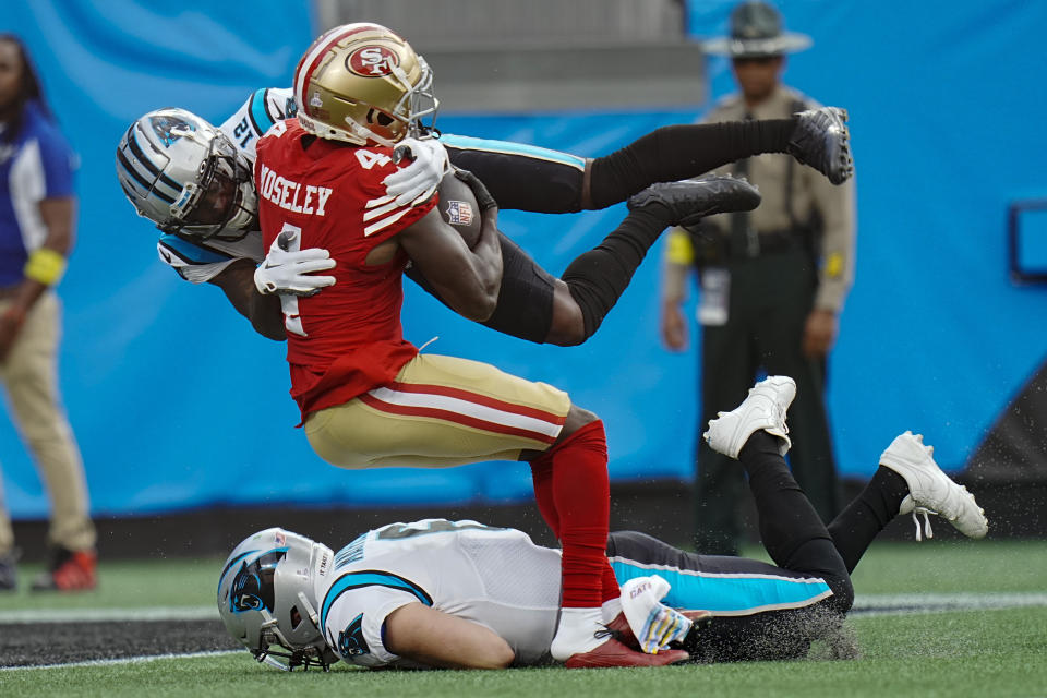 San Francisco 49ers cornerback Emmanuel Moseley scores between Carolina Panthers wide receiver Shi Smith and quarterback Baker Mayfield after an interception during the first half an NFL football game on Sunday, Oct. 9, 2022, in Charlotte, N.C. (AP Photo/Rusty Jones)