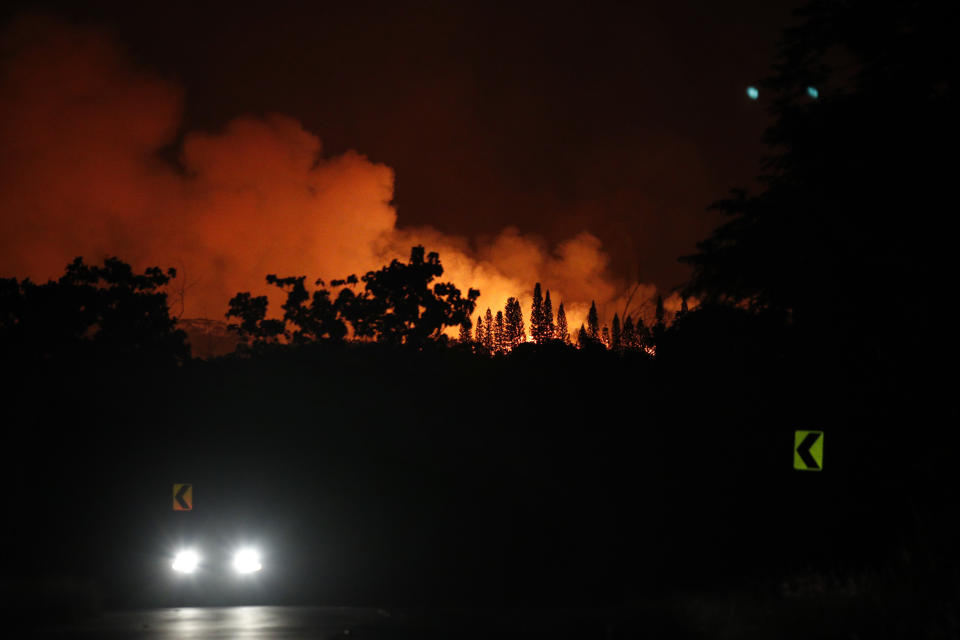 <p>A vehicle moves along the road as lava erupts from a fissure near Pahoa, Hawaii May 19, 2018. (Photo: Jae C. Hong/AP) </p>