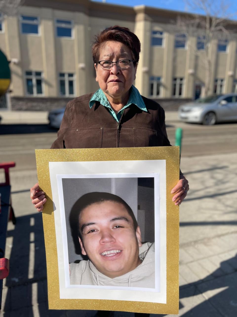 Virginia Pierre holds a photo of her nephew, Dale Culver, outside the Prince George courthouse. 