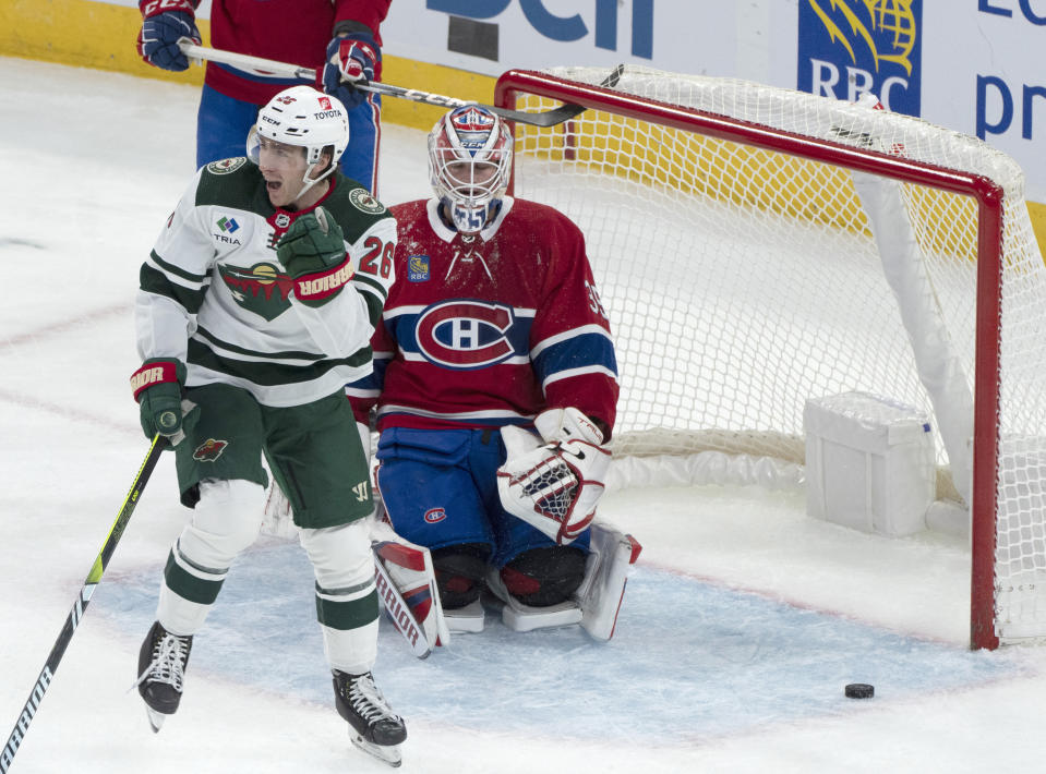 Minnesota Wild center Connor Dewar (26) celebrates his goal over Montreal Canadiens goaltender Sam Montembeault (35) during the first period of an NHL hockey game, Tuesday, Oct. 17, 2023 in Montreal. (Christinne Muschi/The Canadian Press via AP)