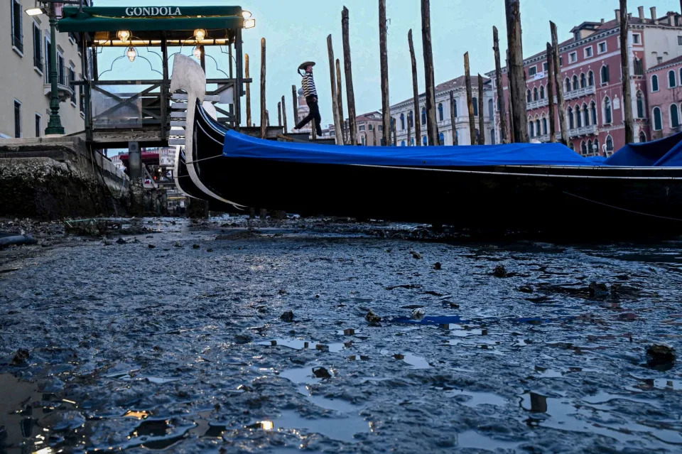 This photograph taken on February 20, 2023, shows gondolas tied up in Venice Canal Grande, during a severe low tide in the lagoon city of Venice.