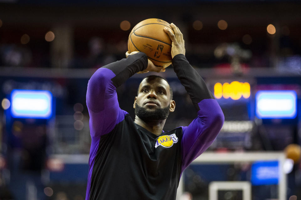FILE - In this Dec. 16, 2018 file photo Los Angeles Lakers forward LeBron James (23) warms up before an NBA basketball game against the Washington Wizards in Washington. It’s not an NBA Finals rematch, but having a matchup between the Lakers and Warriors headline Christmas makes sense. LeBron James faces his old rival on the holiday for the fourth consecutive year Tuesday, Dec. 25, 2018 and this will be his first time playing against Golden State since he moved to Los Angeles. (AP Photo/Al Drago, file)