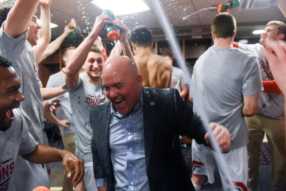 Belmont coach Casey Alexander celebrates with his players in the locker room after being Murray State Saturday in the OVC Tournament championship at Ford Center in Evansville, Indiana.