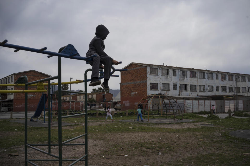 A child plays in a playground in Cape Flats, and area in Cape Town, South Africa, notorious for its gang wars and high numbers of child murders, on Sept. 11, 2020. (AP Photo/Bram Janssen)