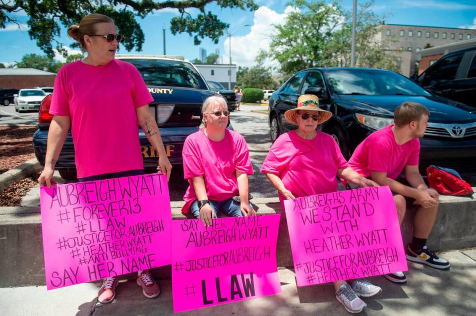 Protestors in support of Heather Wyatt and Aubreigh Wyatt hold signs outside the Jackson County Courts building on Thursday, July 18, 2024, as Heather Wyatt participates in a chancery court hearing inside the courthouse.