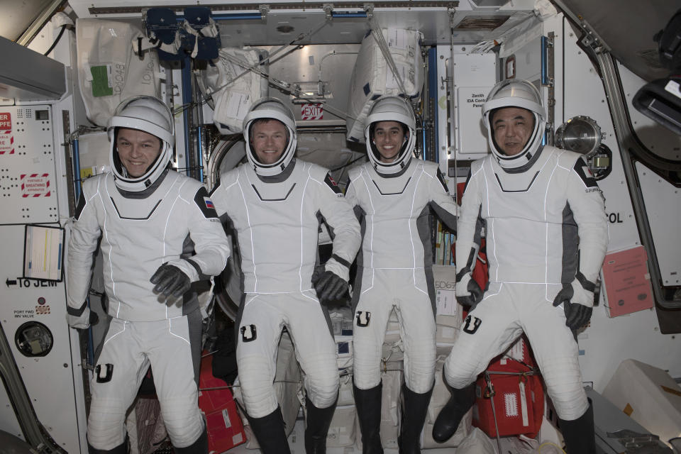 This undated photo provided by NASA shows four Expedition 70 crew mates posing in the pressure suits they will wear when they return to Earth aboard the SpaceX Dragon 