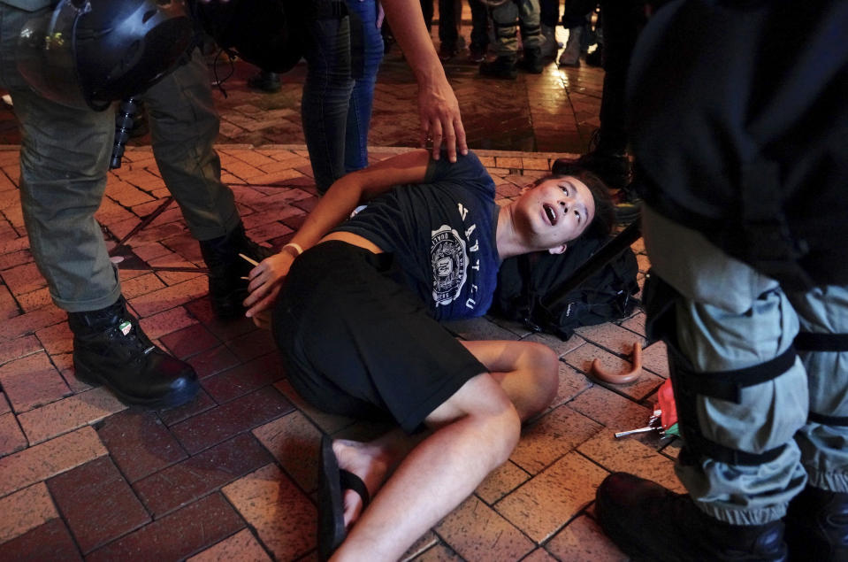 Riot police detain a protester in Hong Kong, Sunday, Sept. 8, 2019. Thousands of demonstrators in Hong Kong urge President Donald Trump to “liberate” the semi-autonomous Chinese territory during a peaceful march to the U.S. consulate, but violence broke out later in the business and retail district after protesters vandalized subway stations, set fires and blocked traffic. (AP Photo/Vincent Yu)