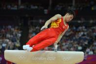 China's gymnast Zhang Chenglong competes on the pommel horse during the men's team final of the artistic gymnastics event of the London Olympic Games at the 02 North Greenwich Arena in London. China won gold