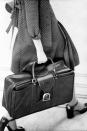 <p>Rectangular briefcases weren't just for work; it became the accessory women brought with them everywhere, and it was more practical than a tiny handbag for stashing all your stuff. </p>