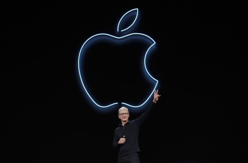 FILE - In this June 3, 2019, file photo, Apple CEO Tim Cook waves after speaking at the Apple Worldwide Developers Conference in San Jose, Calif. Cook has forged his own distinctive legacy. He will mark his ninth anniversary as Apple's CEO Monday, Aug. 24, 2020 -- the same day the company will split its stock for the second time during his reign. (AP Photo/Jeff Chiu, File)