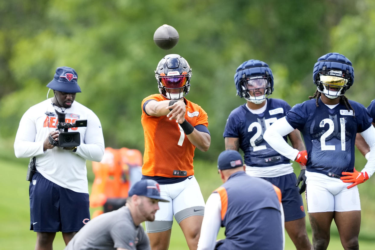 Justin Fields (1) is in the same offensive system as last season, and that familiarity coupled with some new weapons has the Bears feeling excited about his growth as a passer. (AP Photo/Charles Rex Arbogast)