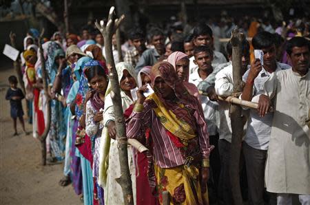 Voters queue at a polling station to cast their votes in Shabazpur Dor village, in Amroha district in the northern Indian state of Uttar Pradesh April 17, 2014. REUTERS/Adnan Abidi