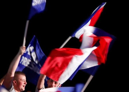 Supporters celebrate with French flags as Marine Le Pen, French National Front (FN) political party leader and candidate for French 2017 presidential election, attends a political rally in Bordeaux, France, April 2, 2017. REUTERS/Regis Duvignau