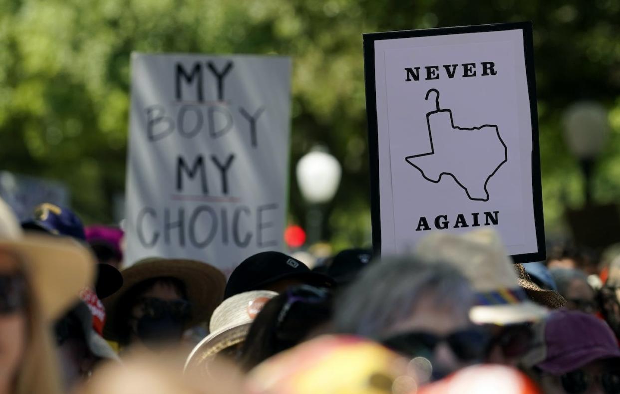 Abortion rights demonstrators hold signs during a rally at the Texas Capitol in May 2022. The state has the most extreme anti-abortion laws in the U.S., and Mexican abortion referral services are now helping American women who require abortions. (AP Photo/Eric Gay)