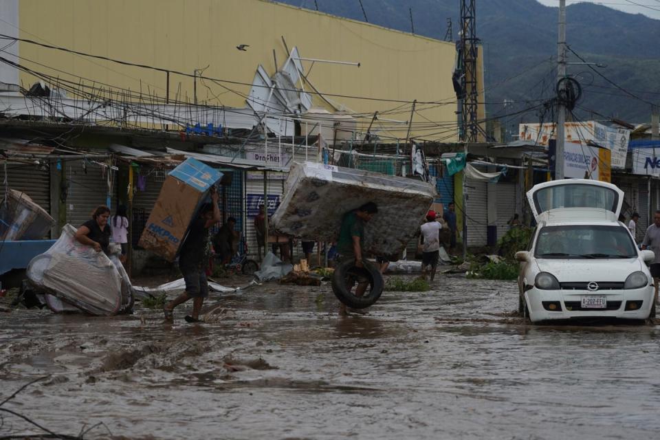 Looters at a shopping mall in Acapulco, Mexico, on Wednesday after Hurricane Otis (AP)