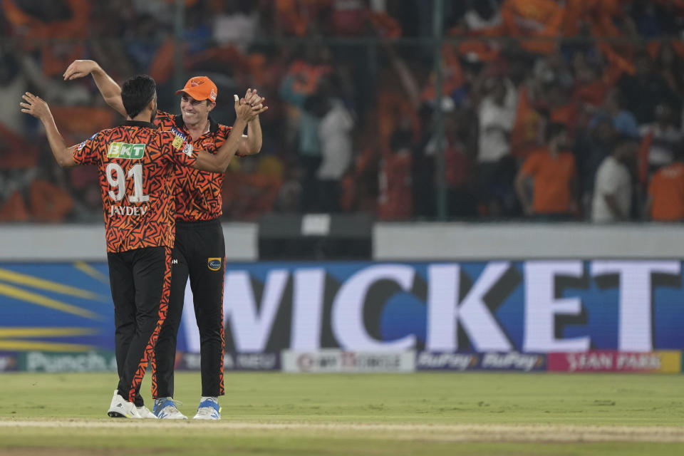 Sunrisers Hyderabad's Jaydev Unadkat, left, celebrates the wicket of Royal Challengers Bengaluru's Rajat Patidar with teammate Pat Cummins during the Indian Premier League cricket match between Royal Challengers Bengaluru and Sunrisers Hyderabad in Hyderabad, India, Thursday, April 25, 2024. (AP Photo/Mahesh Kumar A.)