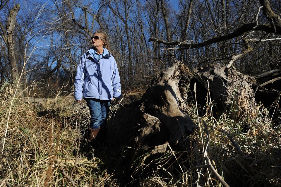 Sandra Cheskey revisits the site Wednesday, Nov. 13, 2013, where she and four friends were hanging out when the Fryer brothers began to shoot at them at Gitchie Manitou State Preserve near Granite, Iowa.