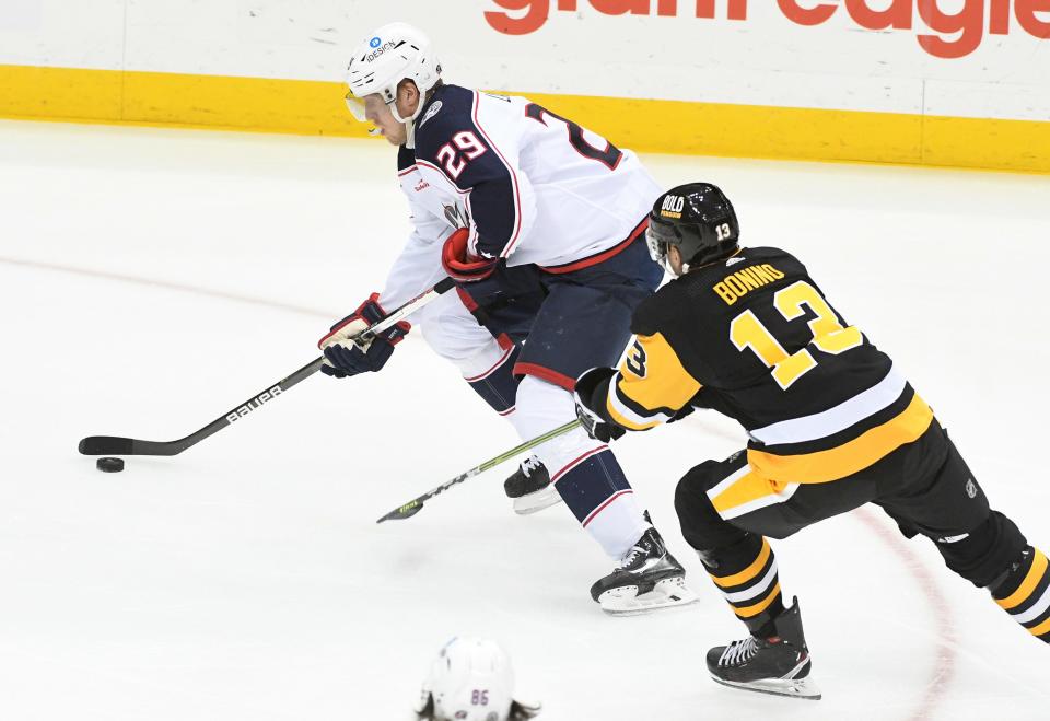 Columbus Blue Jackets ledft wing Patrik Laine (29) skates from Pittsburgh Penguins center Nick Bonino (13) during the first period of an NHL hockey game, Tuesday, March 7, 2023, in Pittsburgh. (AP Photo/Philip G. Pavely)