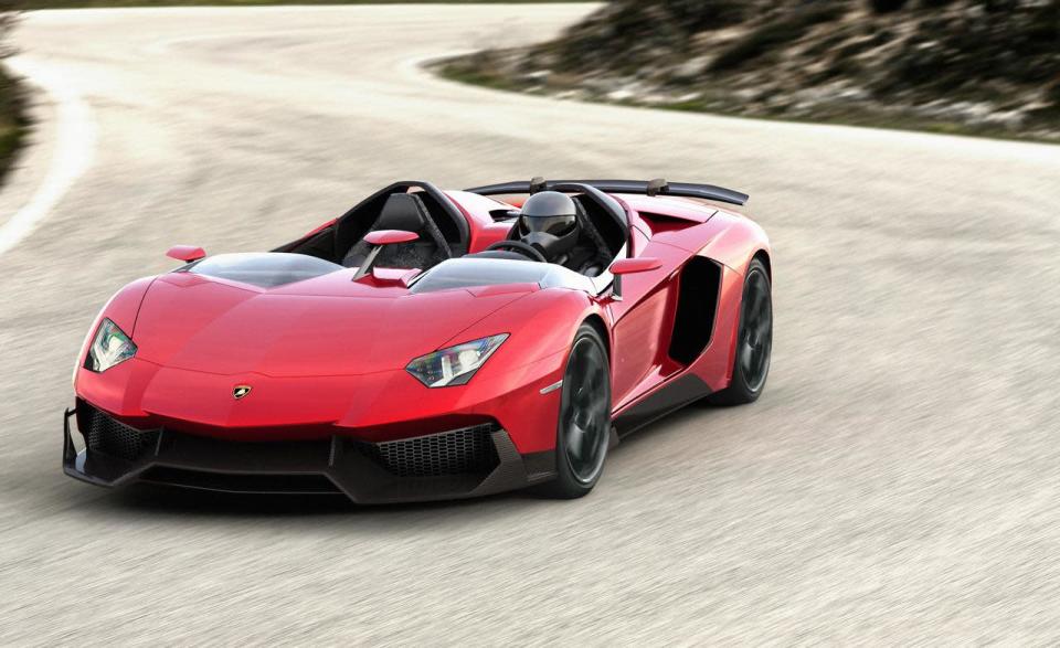 Starting with the everyday 700-hp Aventador, Lamborghini taunted the bull even further by removing the roof, adding several aerodynamic panels and generally shucking weight from a car that only had 3,472 lbs. to begin with. Even the seat fabrics have been swapped for something Lamborghini calls "Carbonskin," a fabric made from carbon fibers that's at least a decade away from being used on a teenager's hat. With no windshield, the interior has to get some form of waterproofing; the rear mirror pops up like Wall-E's head from the center of the dash. It and the roll bars behind the driver are the highest points in the car.