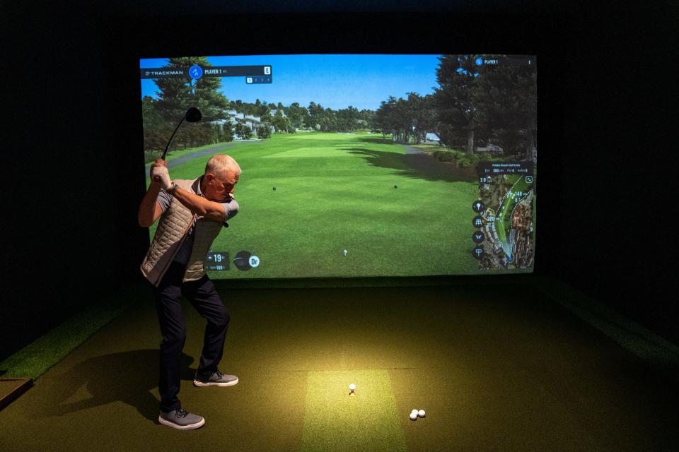 Jim Bucklin, owner of TeeBox Indoor Golf Club, demonstrates a swing inside his business in Cave Creek on February 13, 2024.