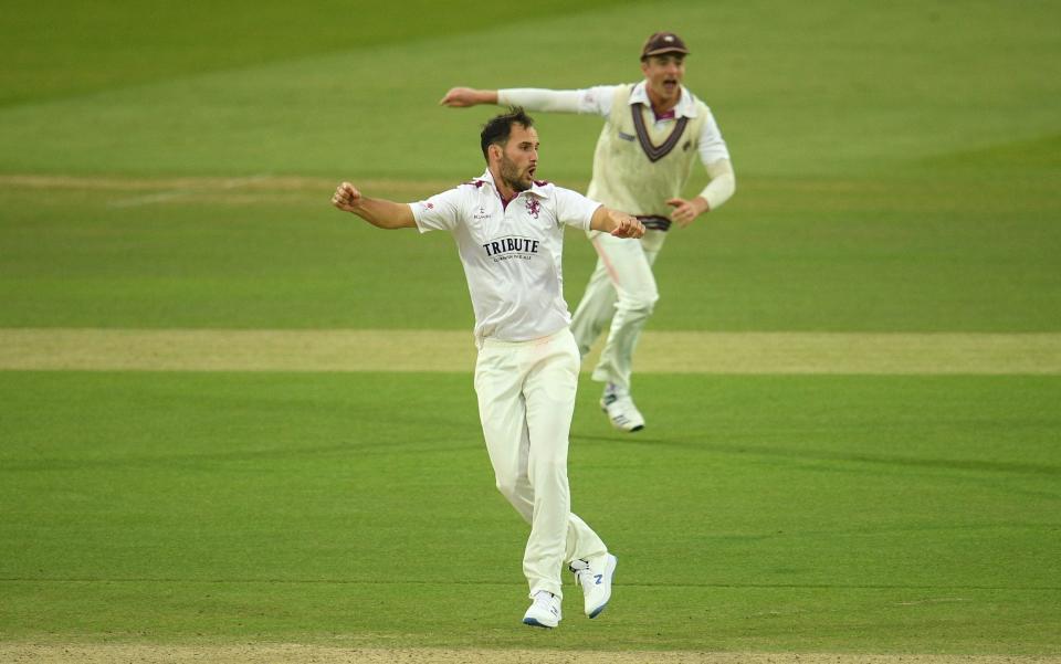 Lewis Gregory(L) and Tom Abell of Somerset(R) celebrate the wicket of Sir Alastair Cook - Getty