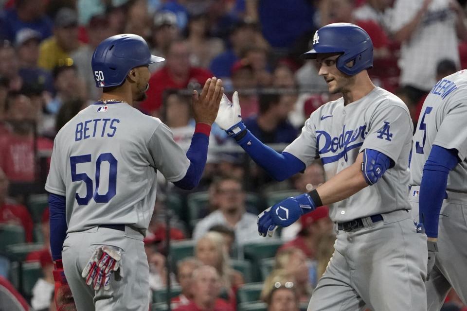 Dodgers' Trea Turner is congratulated by teammate Mookie Betts after hitting a two-run home run.