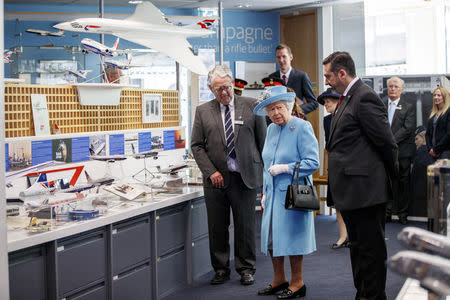 Britain's Queen Elizabeth looks exhibits in the Heritage Centre during her visit to the headquarters of British Airways, as British Airways mark their centenary year, in Heathrow, west London, Britain May 23, 2019. Tolga Akmen/Pool via REUTERS