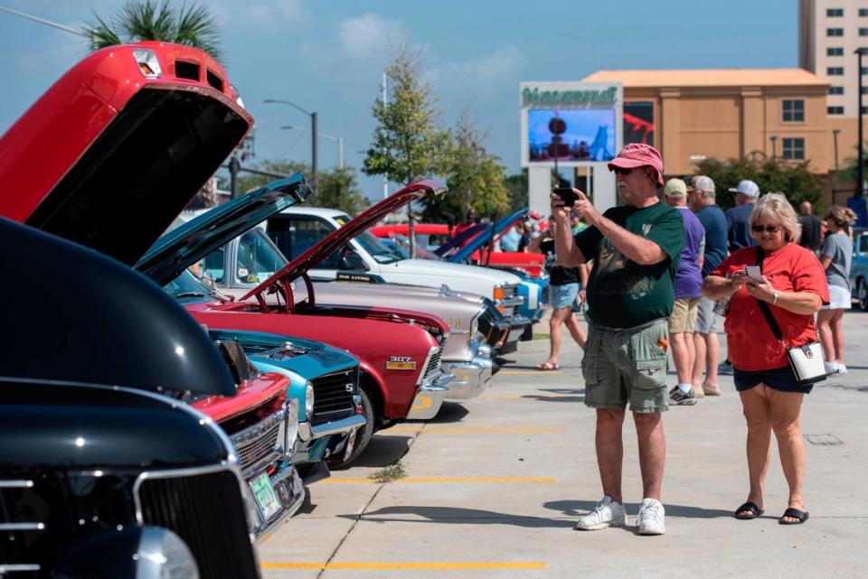 Spectators photograph cars at Paradise Pier during Cruisin’ the Coast on Tuesday, Oct. 3, 2023.