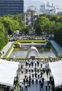 <p>People attend a ceremony to mark the 72nd anniversary of the world’s first atomic bombing that killed 140,000 people at the Peace Memorial Park in Hiroshima, western Japan, Sunday, Aug. 6, 2017. Hiroshima’s appeal of “never again” on the 72nd anniversary has acquired renewed urgency as North Korea moves ever closer to acquiring nuclear weapons. (Photo: Ryosuke Ozawa/Kyodo News via AP) </p>