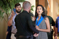 A police officer removes a protester (R) during the Wells Fargo annual shareholder meeting in Jacksonville, Florida, U.S., April 25, 2017. REUTERS/Phelan Ebenhack