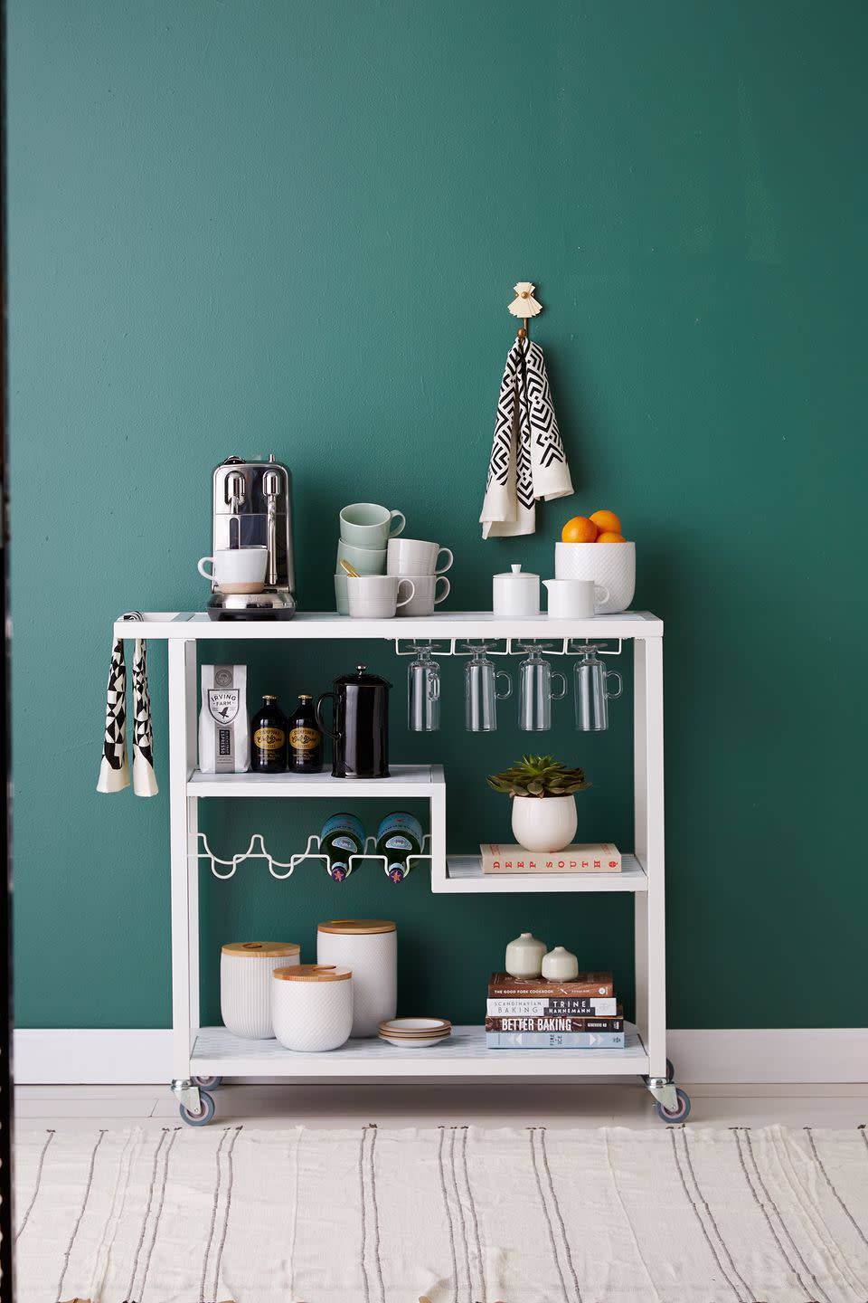 <p>If you're in need of extra space to store your coffee maker and kitchen essentials, a bar cart is a no-fail solution. Add a small succulent and bowl of citrus to create more visual appeal. </p>