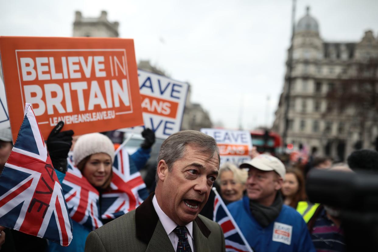 Crowds hold pro-Brexit signs and Union Jack flags near former UKIP Leader Nigel Farage outside Britain's Parliament in London on Jan. 15, 2019.