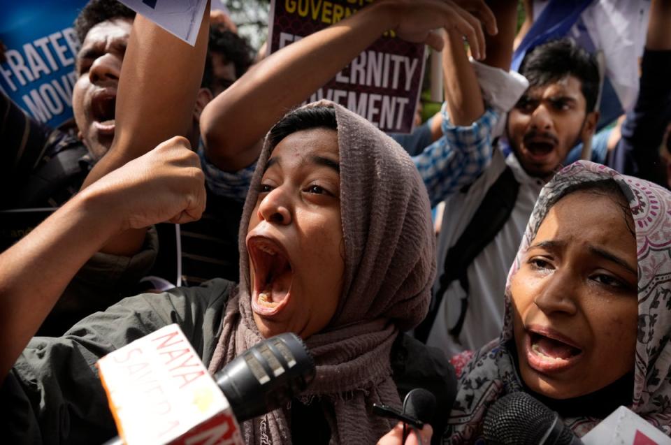 Muslim students shout anti-government slogans during a protest outside Uttar Pradesh house, in New Delhi, Monday, 13 June 2022 (AP)