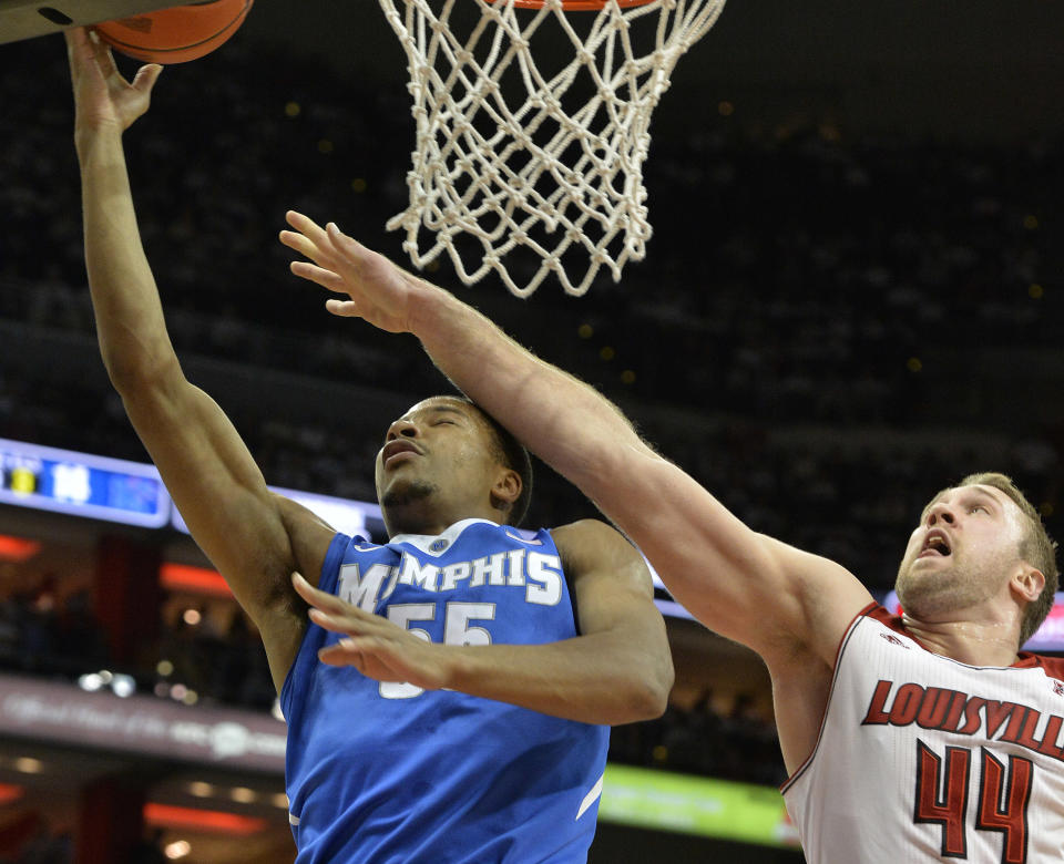 Memphis' Geron Johnson, left, is fouled by Louisville's Stephan Van Treese while attempting to shoot during the first half of an NCAA college basketball game on Thursday Jan. 9, 2014, in Louisville, Ky. (AP Photo/Timothy D. Easley)