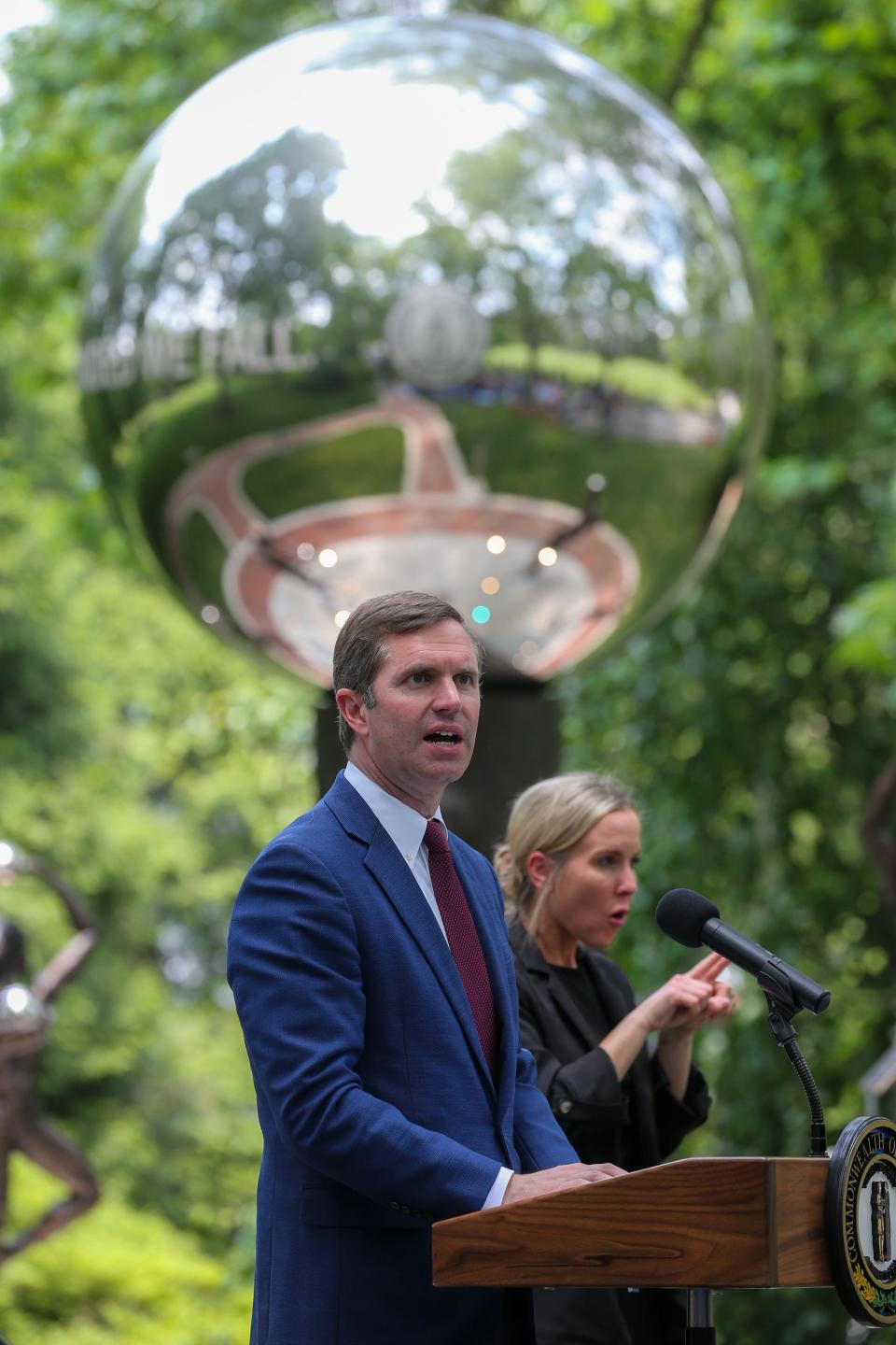 Kentucky Governor Andy Beshear speaks before a crowd of about 200 gathered for The United We Stand, Divided We Fall COVID-19 memorial dedicated in Frankfort at the Kentucky State Capitol on Wednesday, May 24, 2023