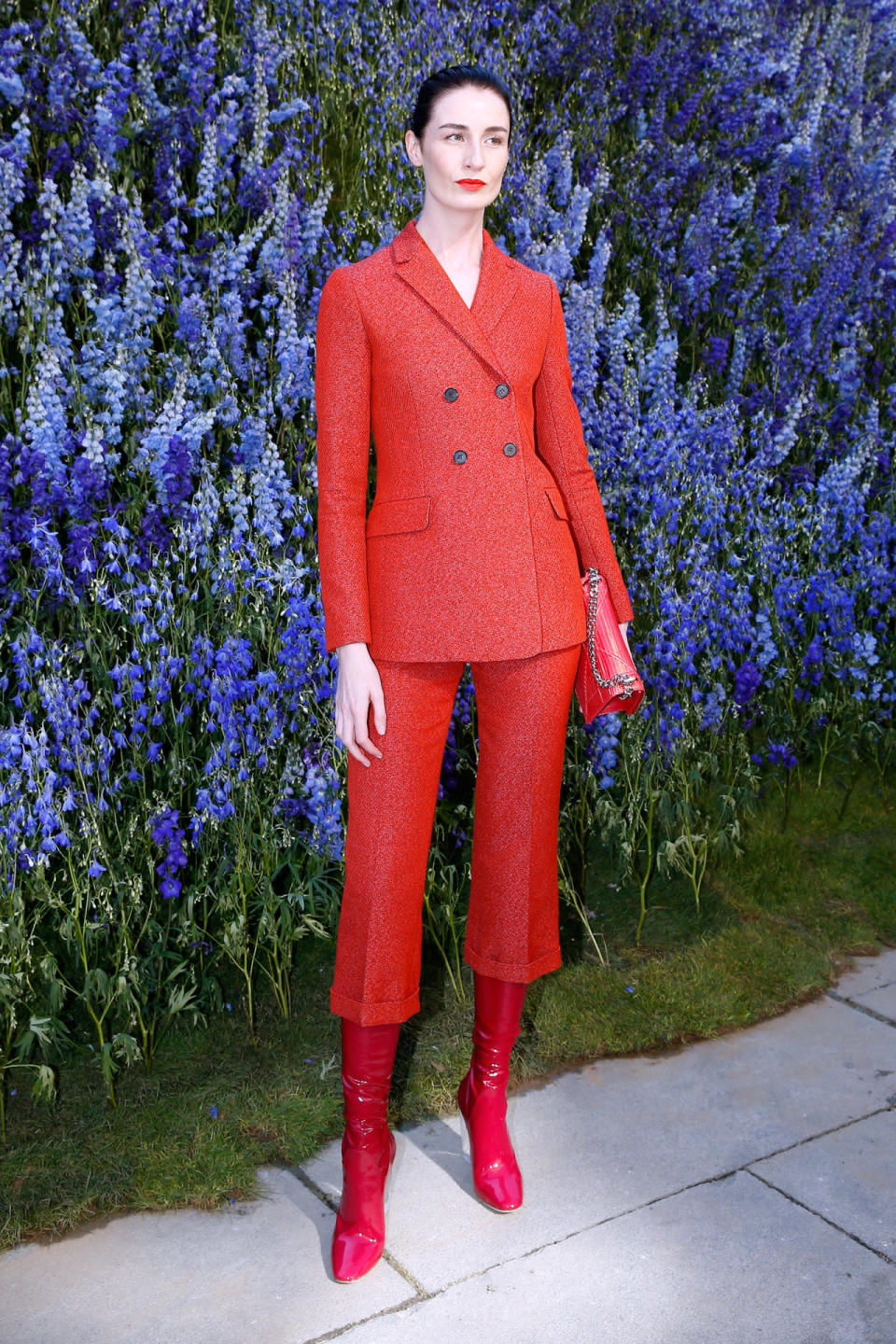 Supermodel Erin O’Connor Outside Dior in a Red Dior Suit. 