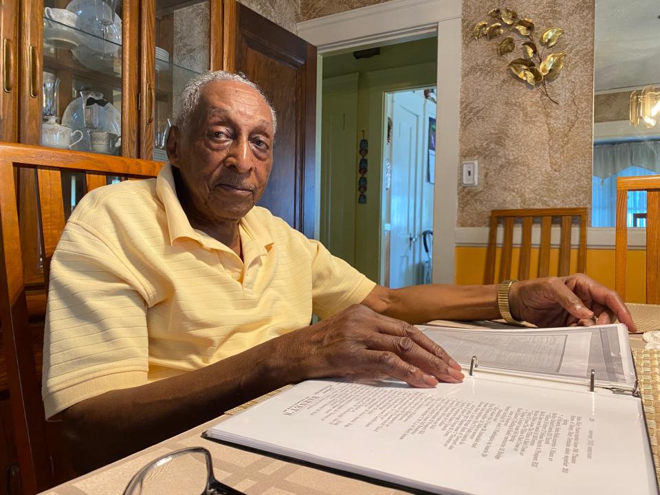 Brad's son, Albert L. Smith, 96, reviews papers about his father in his Providence home on July 24. Albert served in the Army and later had other jobs, including nine years at Hasbro as a designer, where he worked on Weebles, among other toys.