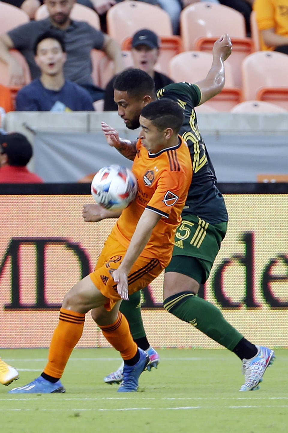 Houston Dynamo midfielder Matias Vera, front, brings down the ball in front of Portland Timbers defender Bill Tuiloma, back during the first half of an MLS soccer match Wednesday, June 23, 2021, in Houston. (AP Photo/Michael Wyke)