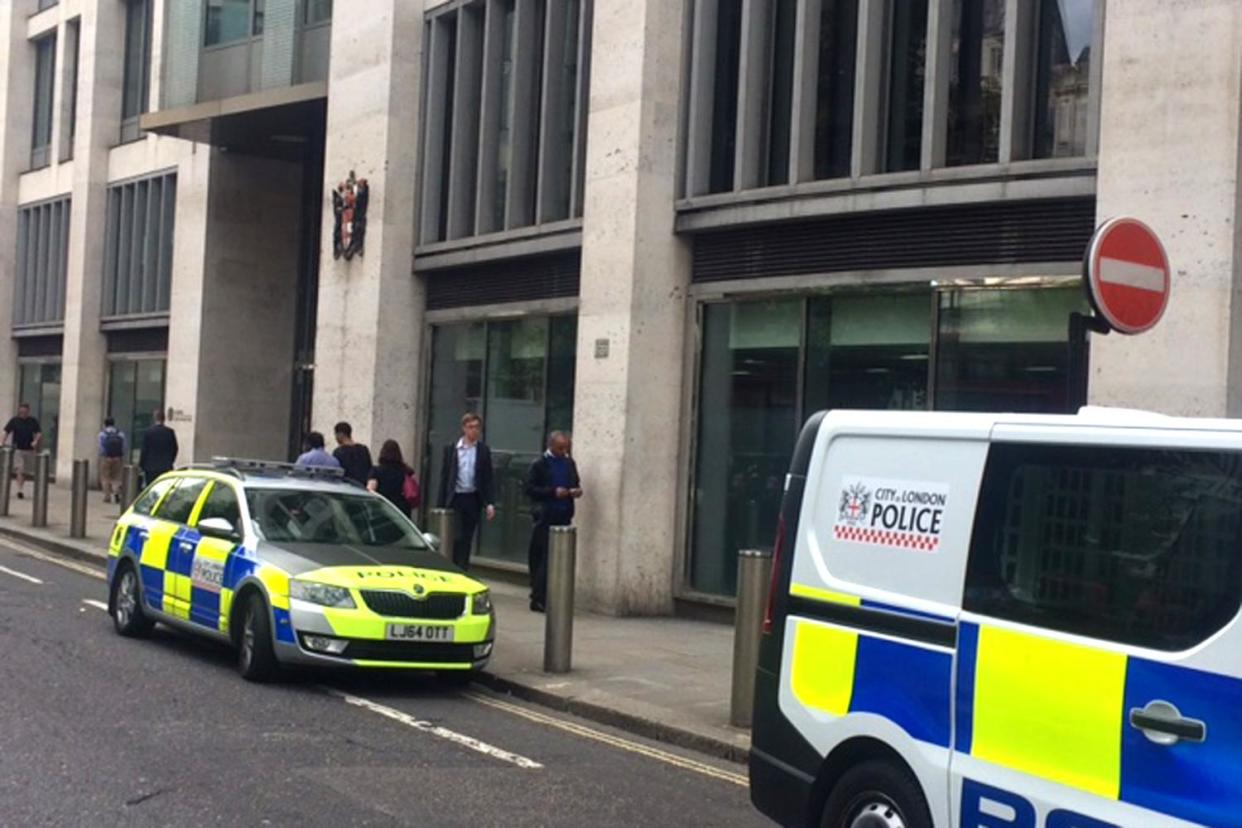 Police at the scene after the man fell to his death from an upper floor of the London Stock Exchange