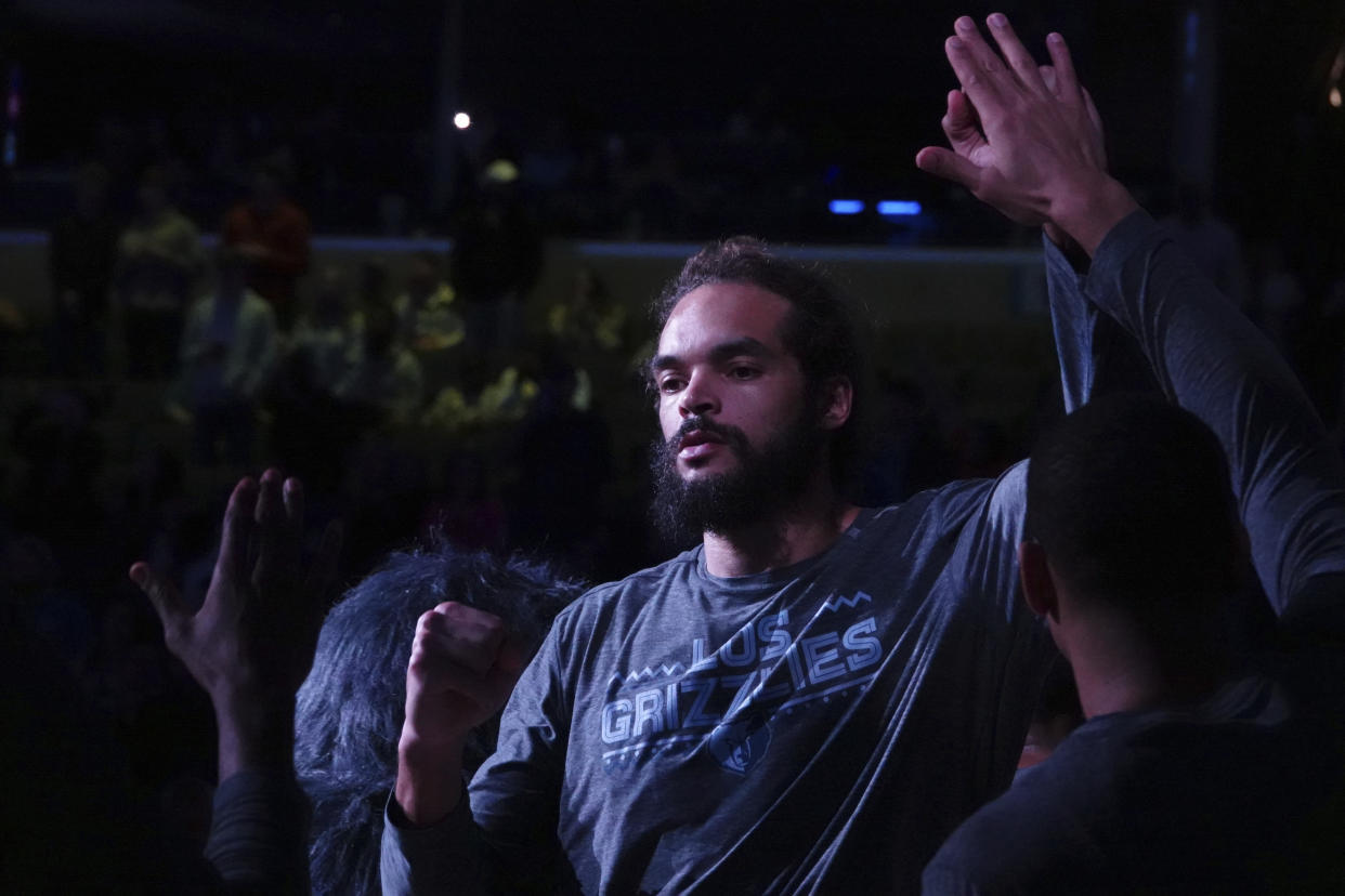 Memphis Grizzlies Joakim Noah (55) come onto the court before the first half of an NBA basketball game Friday, March 8, 2019, in Memphis, Tenn. (AP Photo/Karen Pulfer Focht)