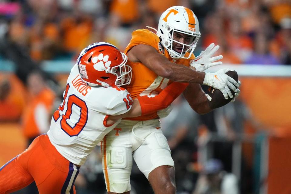 Dec 30, 2022; Miami Gardens, FL, USA; Tennessee Volunteers wide receiver Bru McCoy (15) scores a touchdown past Clemson Tigers cornerback Jeadyn Lukus (10) during the first half of the 2022 Orange Bowl at Hard Rock Stadium. Mandatory Credit: Jasen Vinlove-USA TODAY Sports